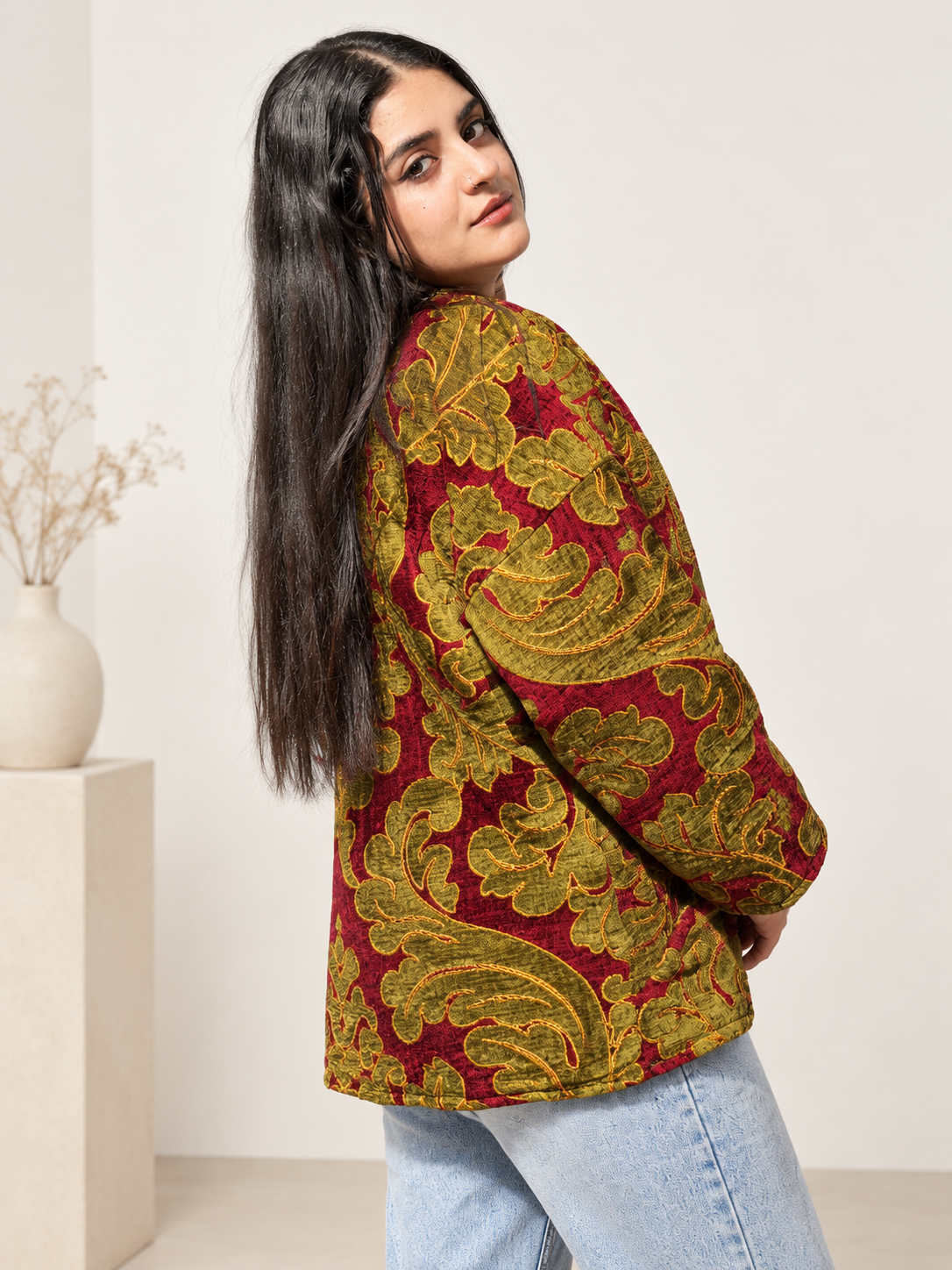 Back view of Fine R Studio burgundy and olive floral velvet jacket showing its relaxed shape and ornate botanical pattern.