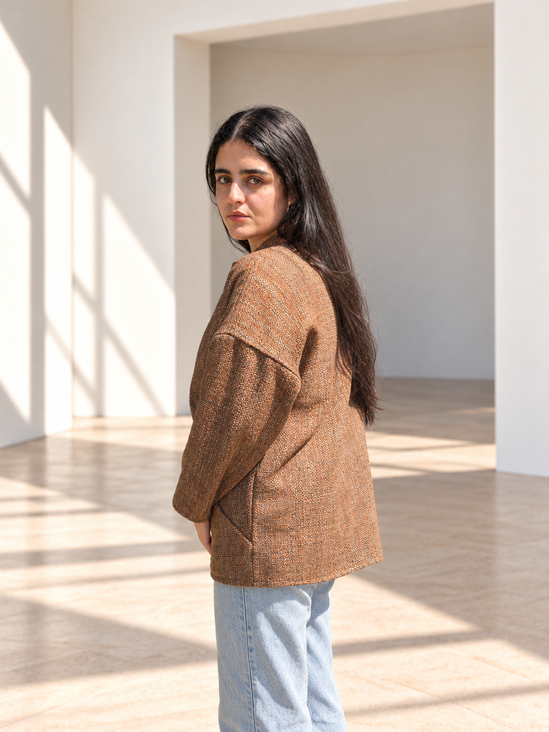 Back view of Fine R Studio copper tweed art jacket showing dropped shoulders and a relaxed shape.