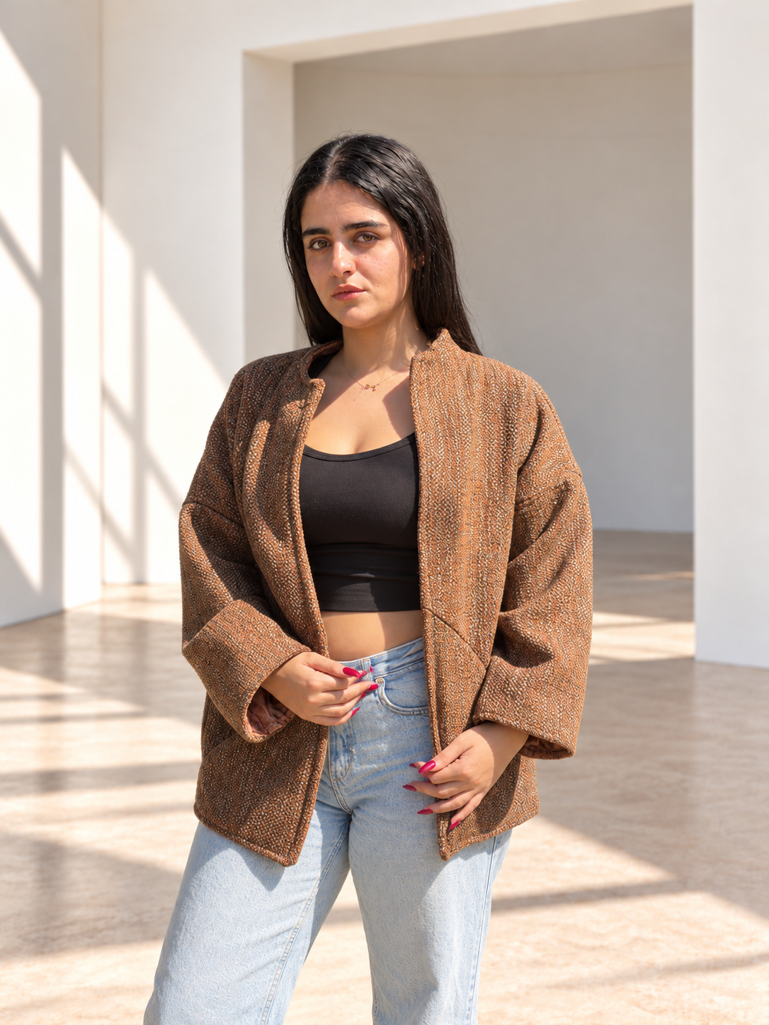 Front view of Fine R Studio copper tweed jacket with an open front and relaxed sleeves.
