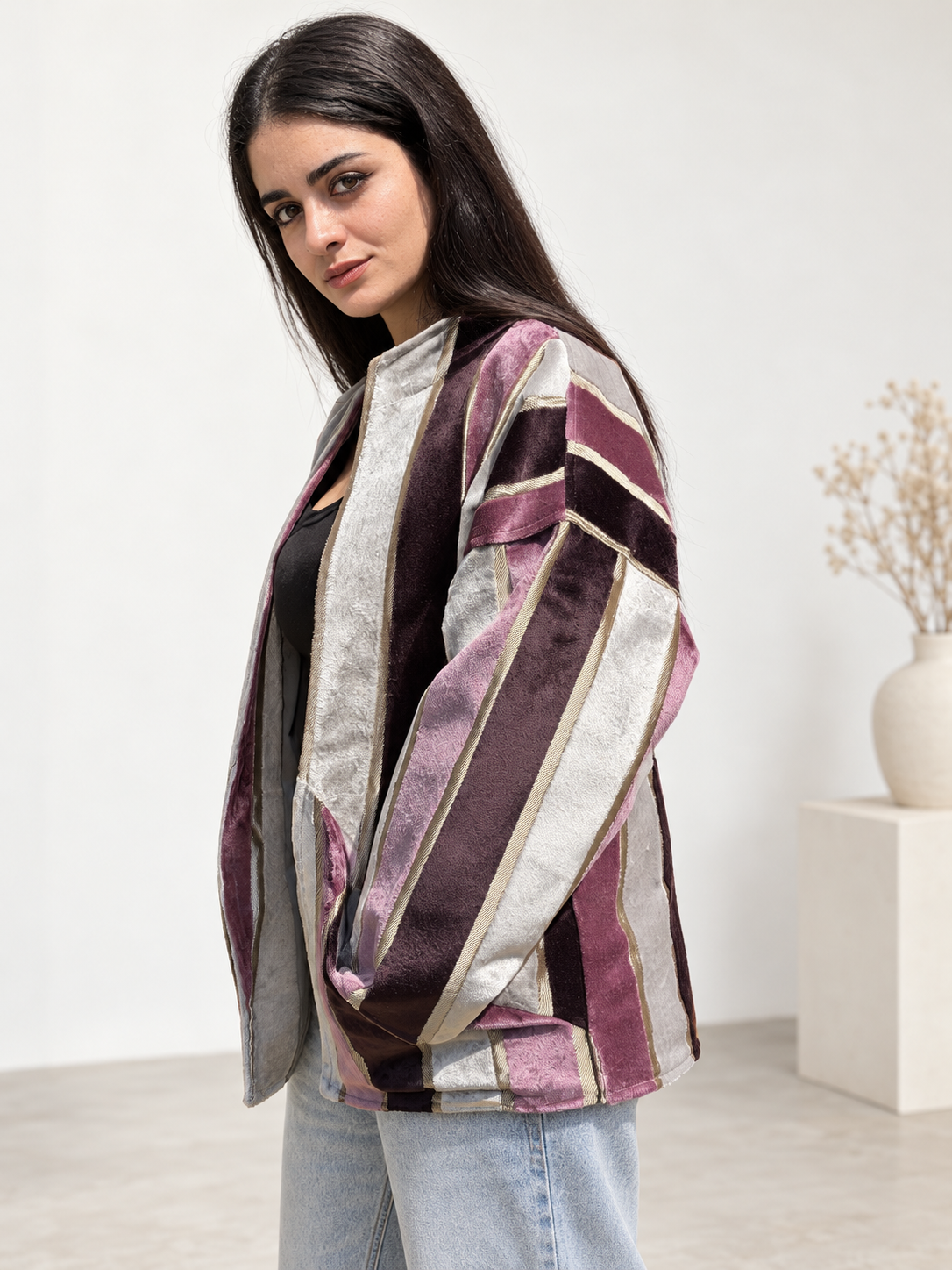Side view of Fine R Studio mauve and ivory striped velvet jacket showing dropped shoulders and a generous sleeve.