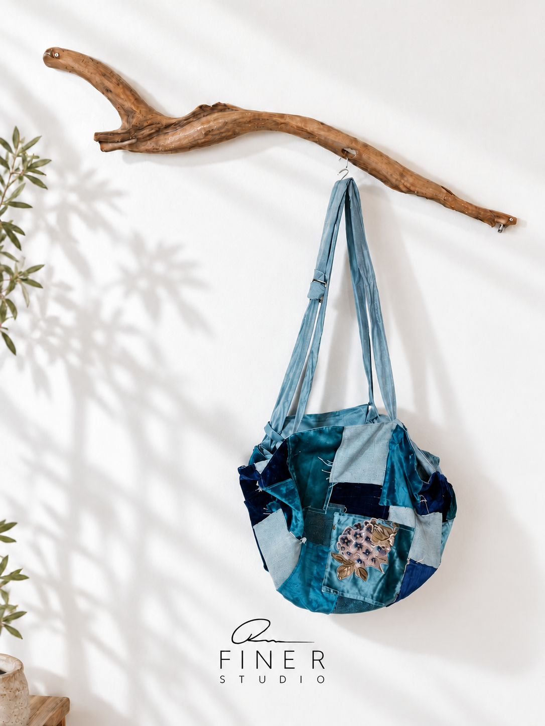 Fine R Studio turquoise and blue patchwork shoulder bag with a floral panel and long straps.
