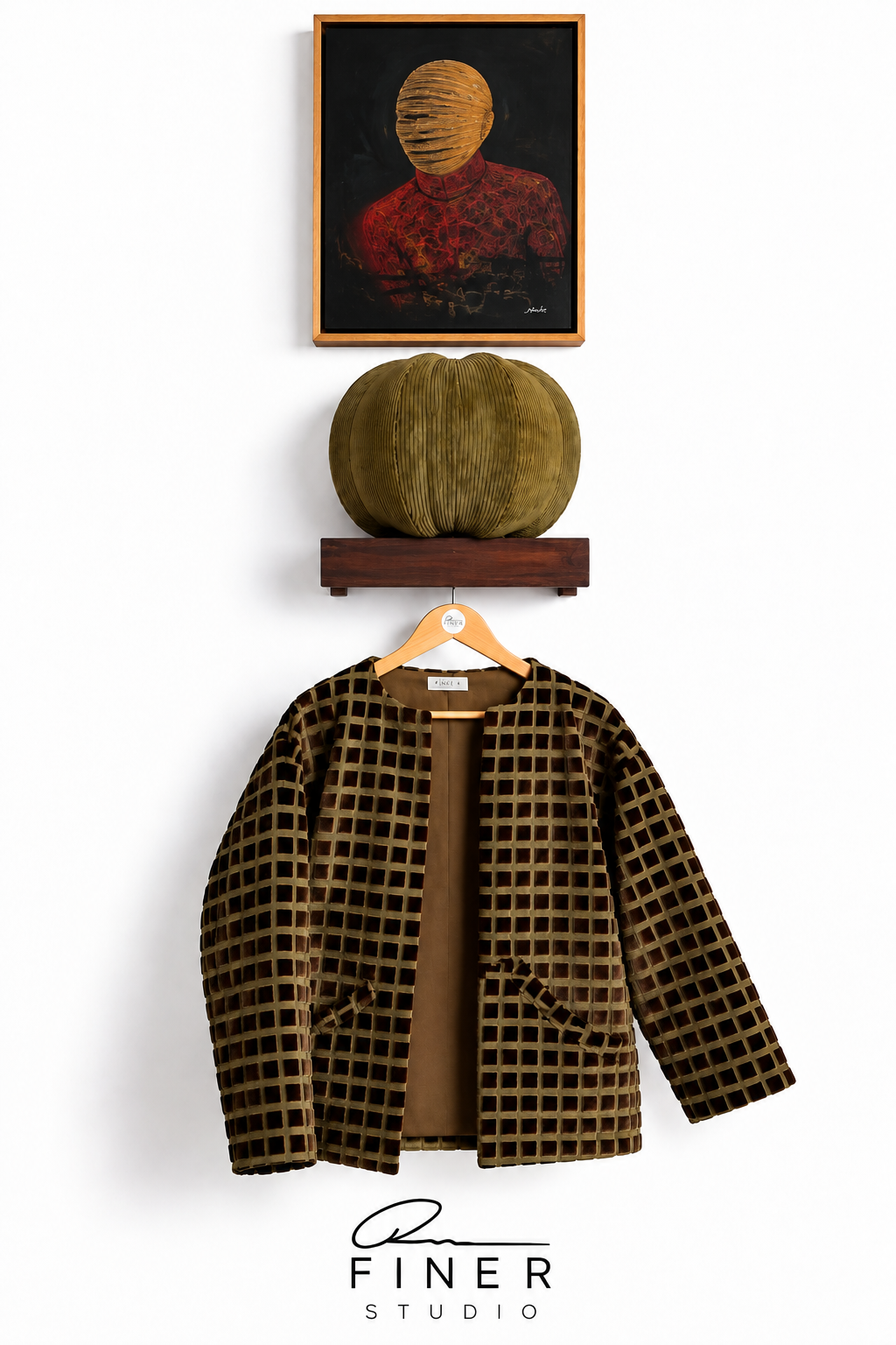 Fine R Studio olive and dark-brown grid-patterned open-front jacket, displayed beneath artwork and a sculptural cushion.