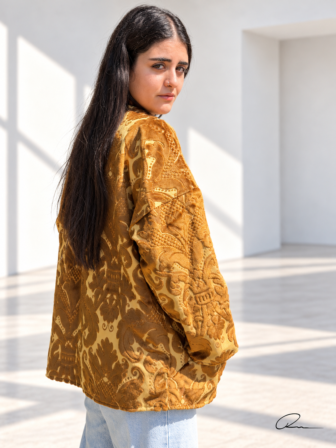 Back view of Fine R Studio gold floral velvet art jacket with a relaxed fit and ornate raised pattern.